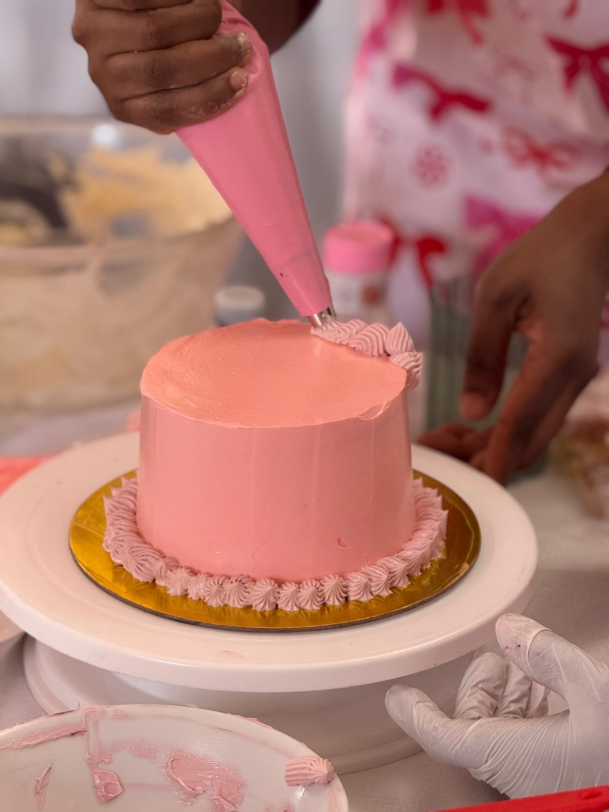 Piping frosting on a cake