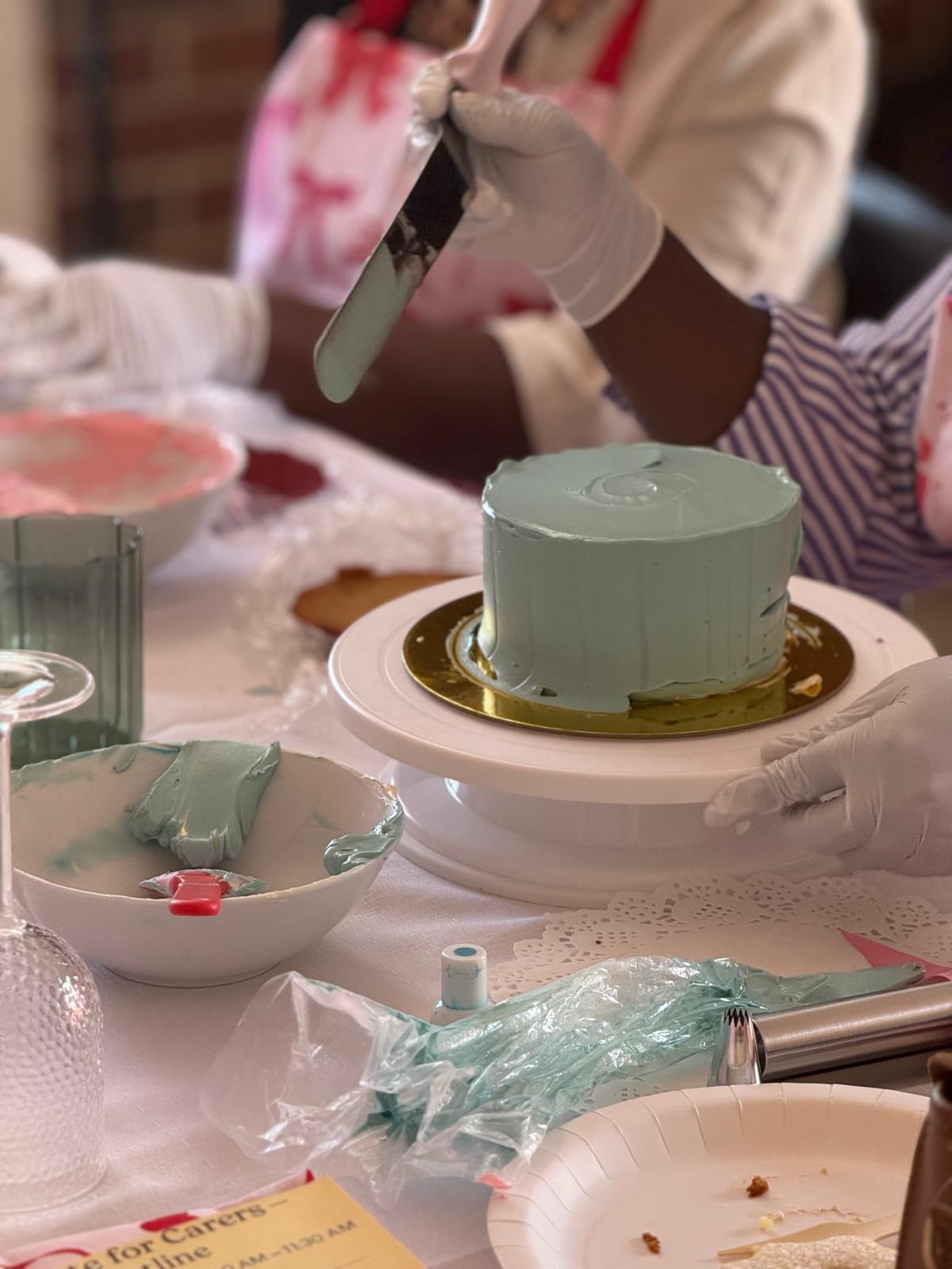 Frosting a teal cake